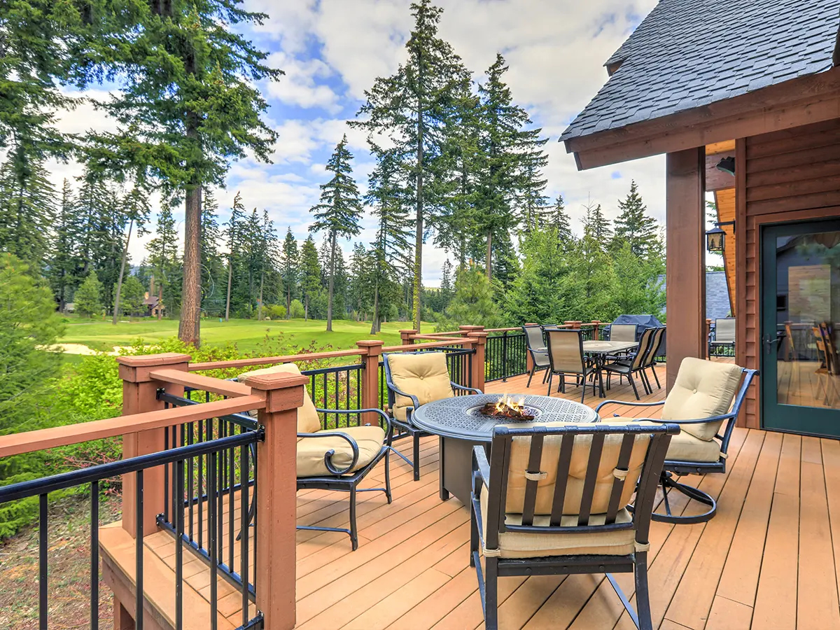 a large outdoor space with outdoor furniture, a fireplace, and metal railings