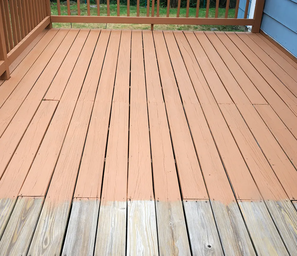 A wood deck being painted in a beige color