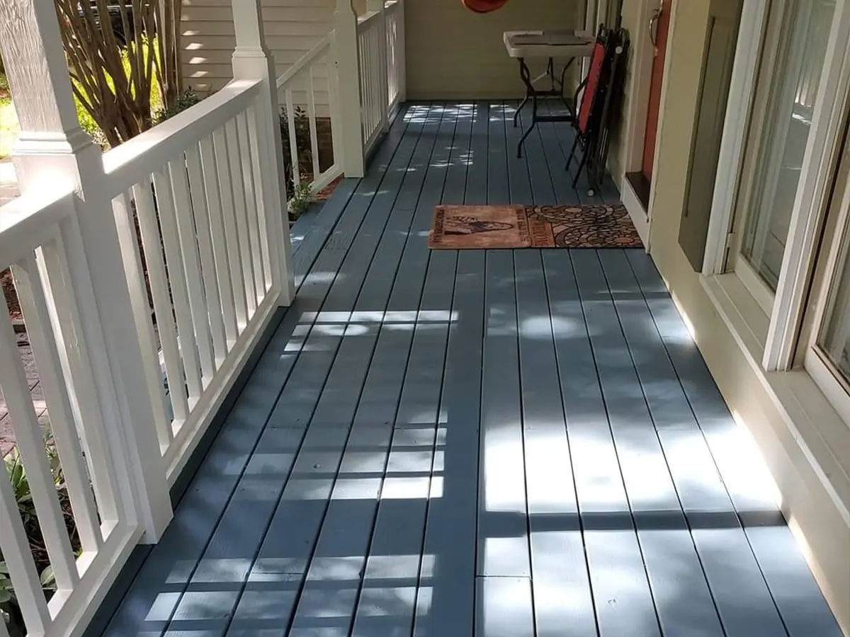 A slate-gray composite deck with white railings