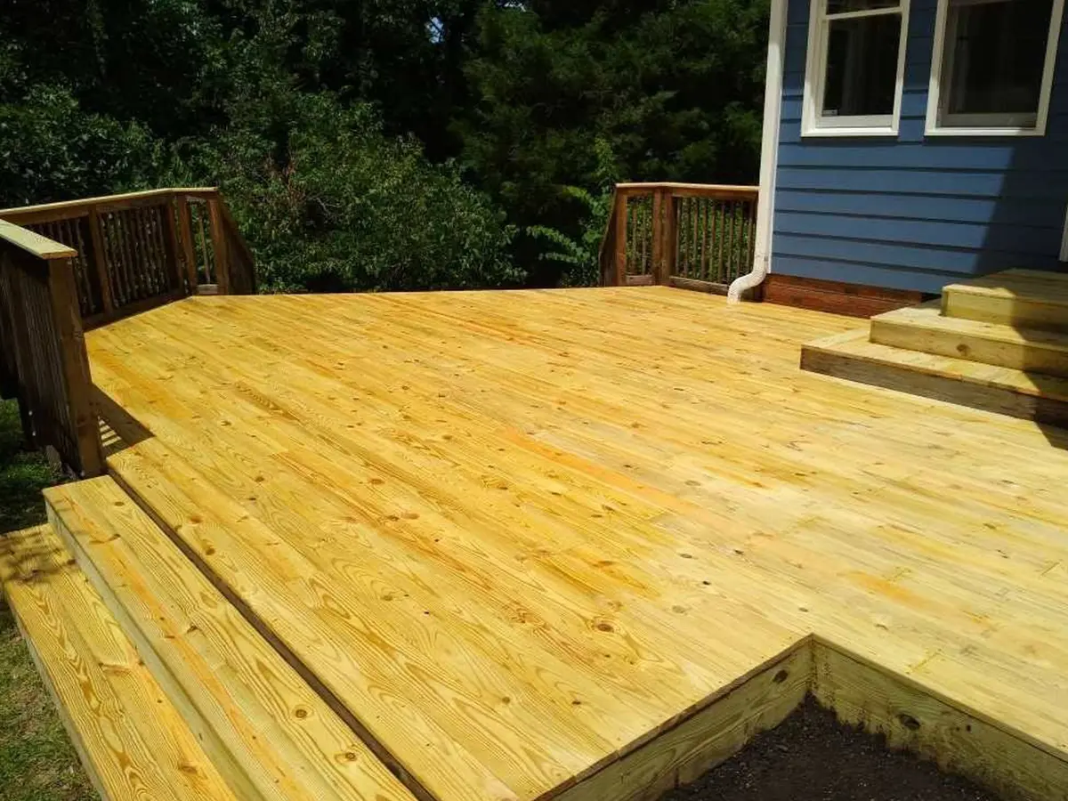 A pressure treated deck and a set of 3 steps to a door