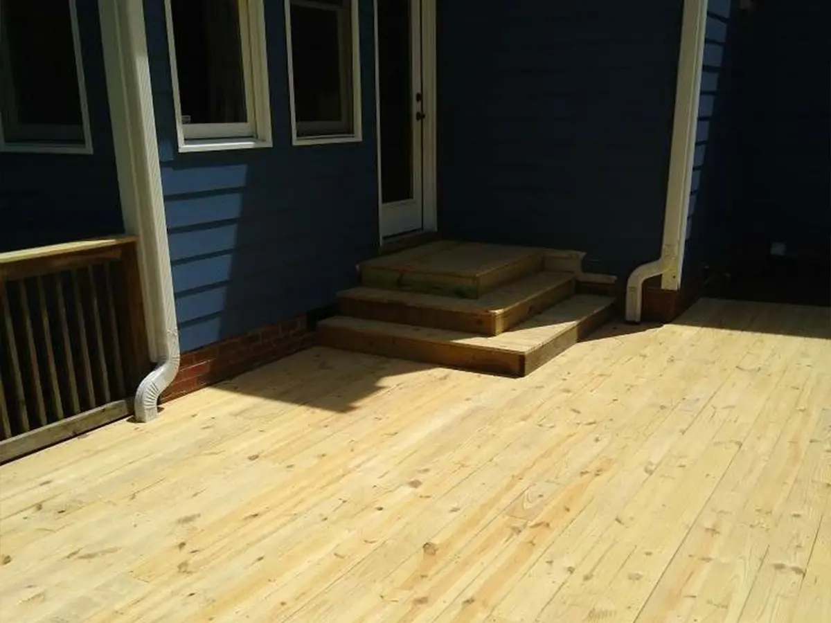 A pressure treated deck and a set of 3 steps to a door
