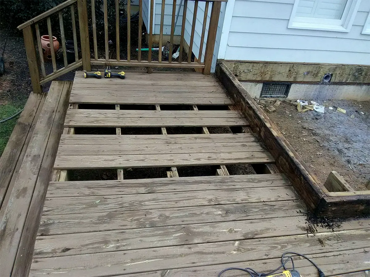 a completely rotten deck frame made of pressure-treated wood