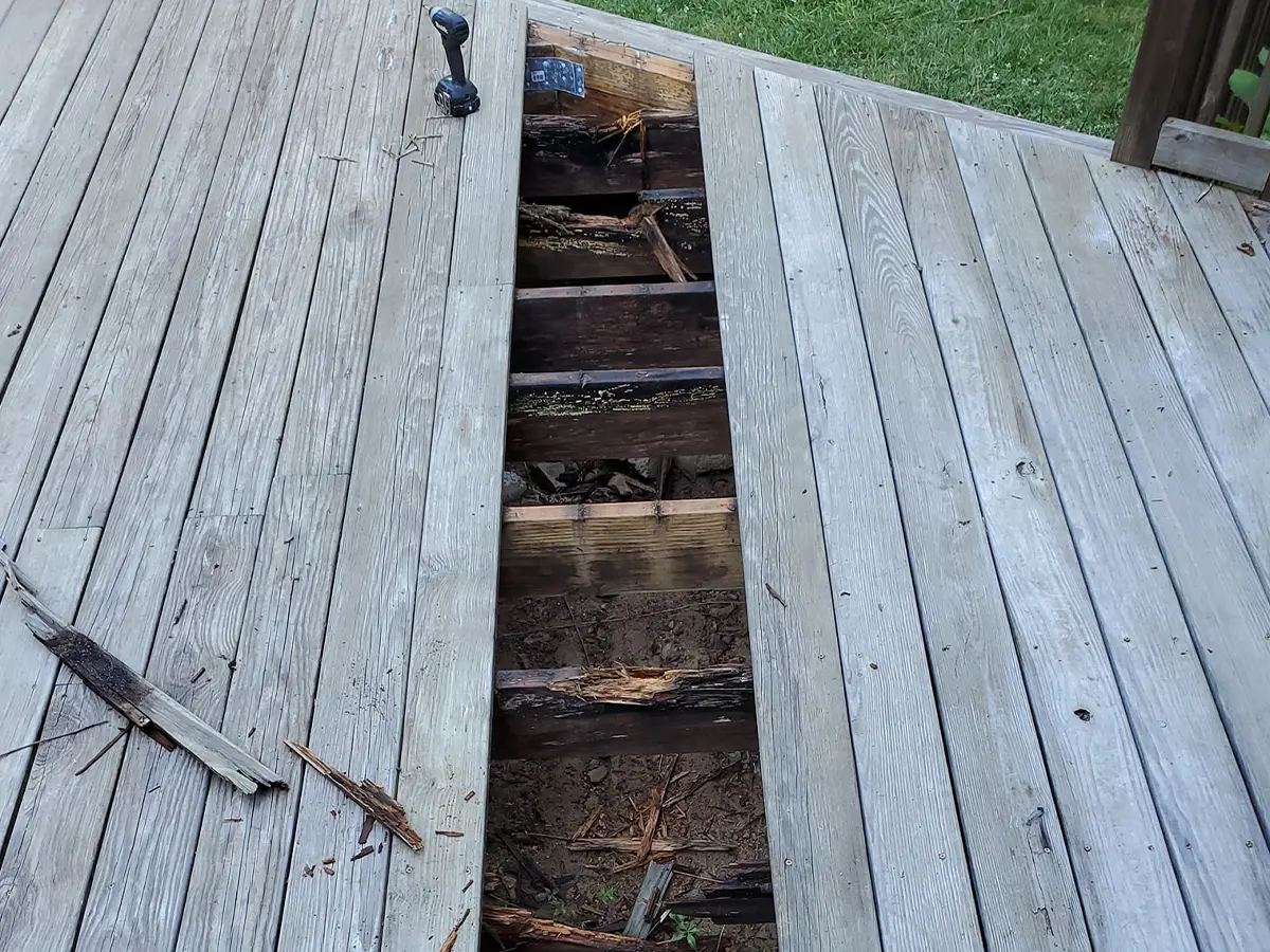 a completely rotten deck frame made of pressure-treated wood