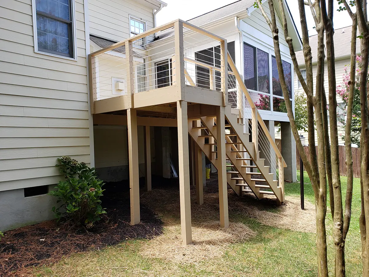 A set of stairs and a small deck that leads to a sunroom