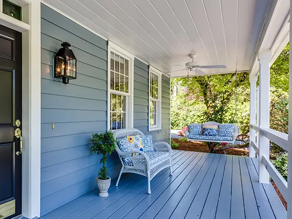 A deck painted gray with white railings