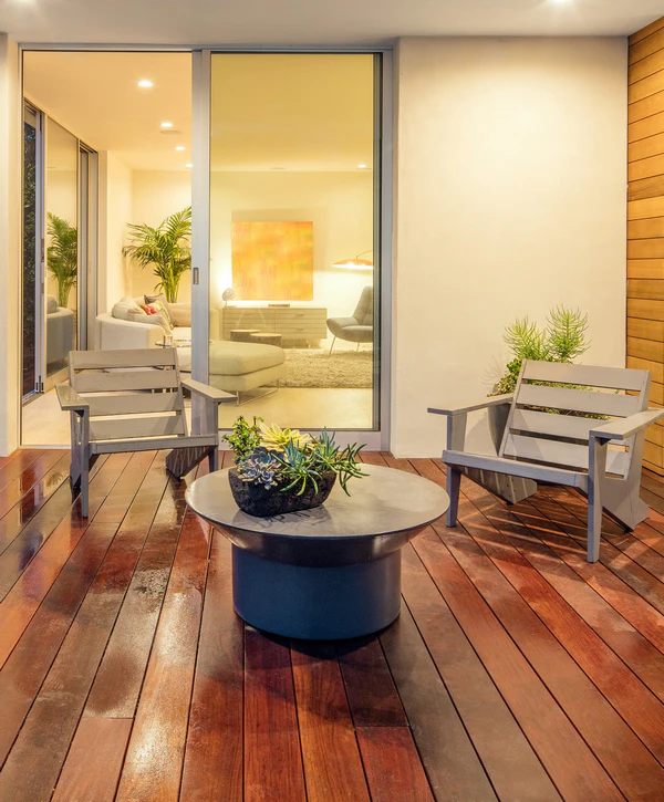 Modern outdoor wood deck with grey lounge chairs and a succulent planter centerpiece in Pittsboro, NC.